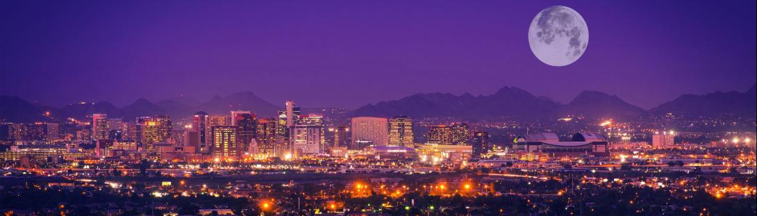photo of the Arizona skyline at night with a full moon 